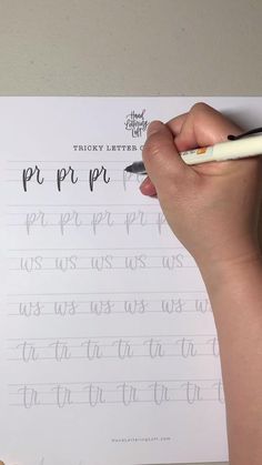 a person writing on a piece of paper with a pen in their left hand and the word prr pro written below it