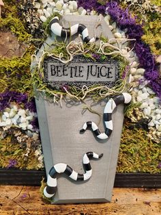 a planter that has some plants growing out of it and the words bee the juice on it