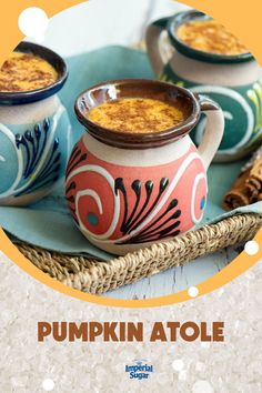 pumpkin atole with cinnamon on the side in a bowl and two mugs next to it