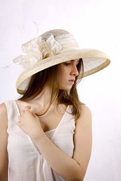 Gorgeous and chic extra wide brim sinamey hat with a astonishing decoration from ivory satin with golden dots, sinamey ribbon with golden stripes and white feathers. The wide brim make it really special and it suits almost all face types. The hat is hand blocked on a wooden block and hand stitched to perfection in Irina Sardareva millinery atelier. It is great to wear on Derby races, Cocktail parties, Weddings, Tea parties, etc.This hat is on stock  size 57 cm / 22.25''.Other sizes and colors ar Elegant White Adjustable Panama Hat, White Elegant Panama Hat, Chic Beige Sun Hat With Curved Brim, Chic Beige Curved Brim Sun Hat, Chic Cream Straw Hat With Flat Brim, Cream Fitted Sun Hat With Flat Brim, Spring Wedding Wide Brim Boater Hat, Fitted Cream Straw Hat With Curved Brim, Cream Sun Hat For Spring Wedding