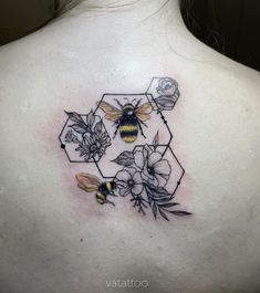 a woman's back with flowers and a bee on it