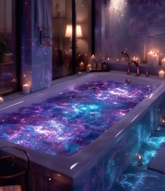 a large bath tub filled with lots of purple and blue liquid next to candles in a bathroom