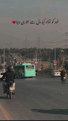 two motorcyclists are riding down the street in front of buses and cars