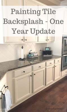 painting tile backsplash one year update with white cabinets and black granite countertops