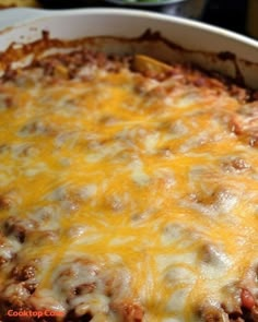 a casserole dish with cheese and meat in it