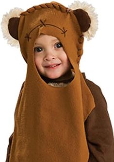 a little boy wearing a brown bear costume