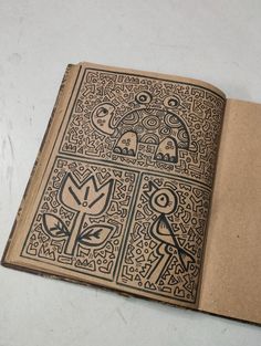 an open book with designs on it