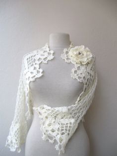 a white crocheted shawl on a mannequin