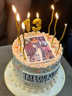 a birthday cake with the number three on it and lit candles in front of it