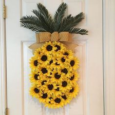 a sunflower wreath hangs on the front door