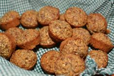 a basket filled with muffins sitting on top of a blue and white checkered cloth