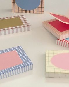 several different colored boxes on a white surface