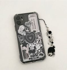 a cell phone case with stickers on it next to a keychain and lanyard