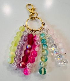 a bunch of beads are hanging from a keychain