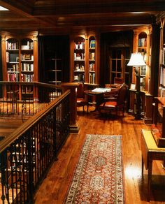 an old library with wooden floors and bookshelves