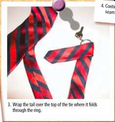 a red and black striped tie hanging from a hook on a piece of paper with the words 3 wrap the tail over the top of the tie where it folds through the ring