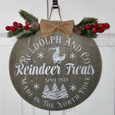 a wooden sign hanging from the side of a door that says rudolph and co reindeer treats made in the north pole