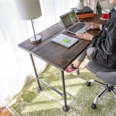 a person sitting at a desk using a laptop computer