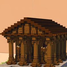 an old building made out of wood with columns and pillars on the outside, in front of a pink sky