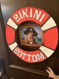 a door with a painting on it that says bkin'bottomom and an image of a man in a pirate hat