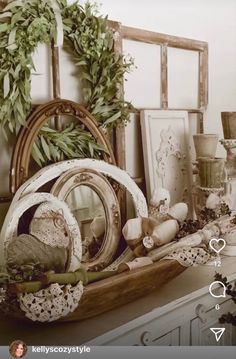 a shelf filled with lots of different items on top of a white dresser next to a mirror