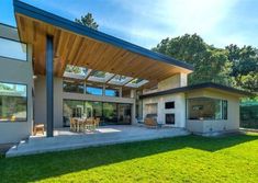 a house with a covered patio in the grass