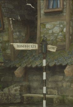 a painting of a street sign in front of a stone building