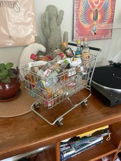 a metal basket filled with food sitting on top of a wooden table next to a record player