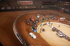 a dirt track with cars on it during a race