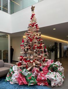 a christmas tree made out of books and wrapped presents