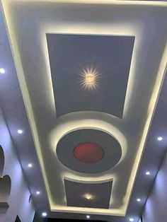 the ceiling in this room is decorated with lights and decorative decorations, including an abstract design