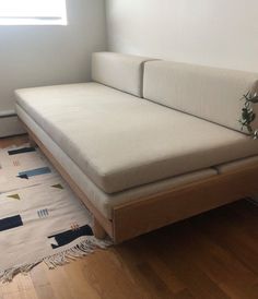 a white couch sitting on top of a wooden floor