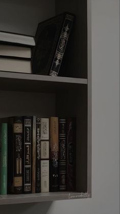 a book shelf filled with lots of books on top of it's white shelves