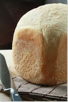 a loaf of bread sitting on top of a table next to a knife