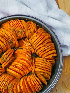 a bowl filled with sliced up sweet potatoes