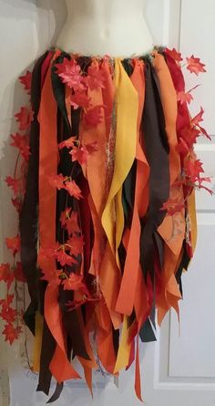 a mannequin is decorated with orange and black ribbons