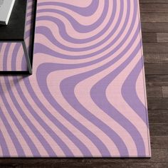 a large rug with wavy lines on the floor in front of a table and chair