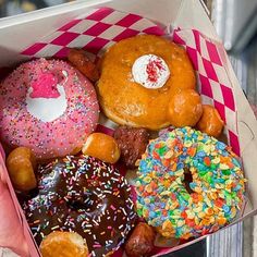 a box filled with lots of different flavored donuts