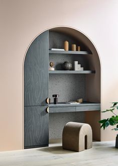 an arch - shaped shelf with shelves and vases on it