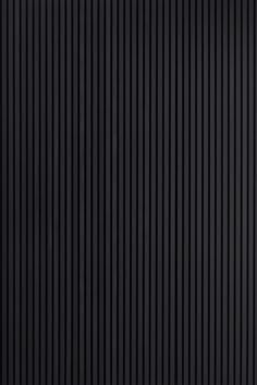 a black wall with vertical lines painted on it