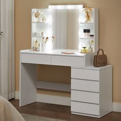 a white vanity with lights on it and a purse in front of the mirror, next to a bed