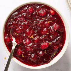 a bowl of cranberry sauce with a spoon in it