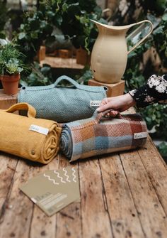 the table is covered with blankets and potted plants