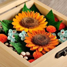 a wooden box filled with fake sunflowers and leaves