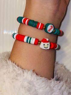 two bracelets that have been decorated with candy canes and snowmen on them