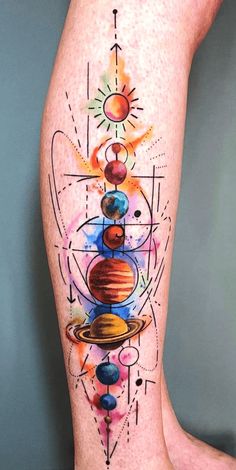 an artistic tattoo on the leg of a woman with planets and sun in it,