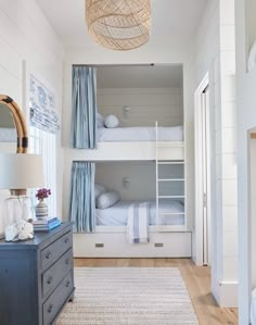 a bedroom with bunk beds and blue curtains