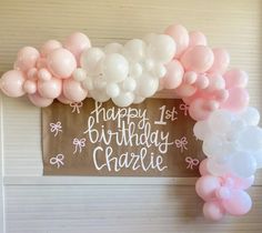 a birthday sign with balloons attached to it