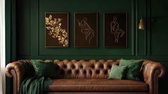 a brown leather couch sitting in front of two green paintings on the wall next to a window