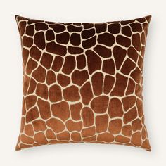 a giraffe print pillow on a white background